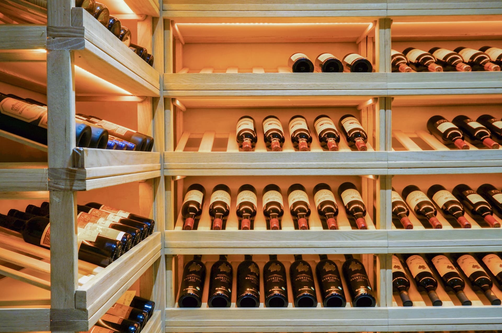 Timber wine racks filled with bottles in a climate controlled cellar
