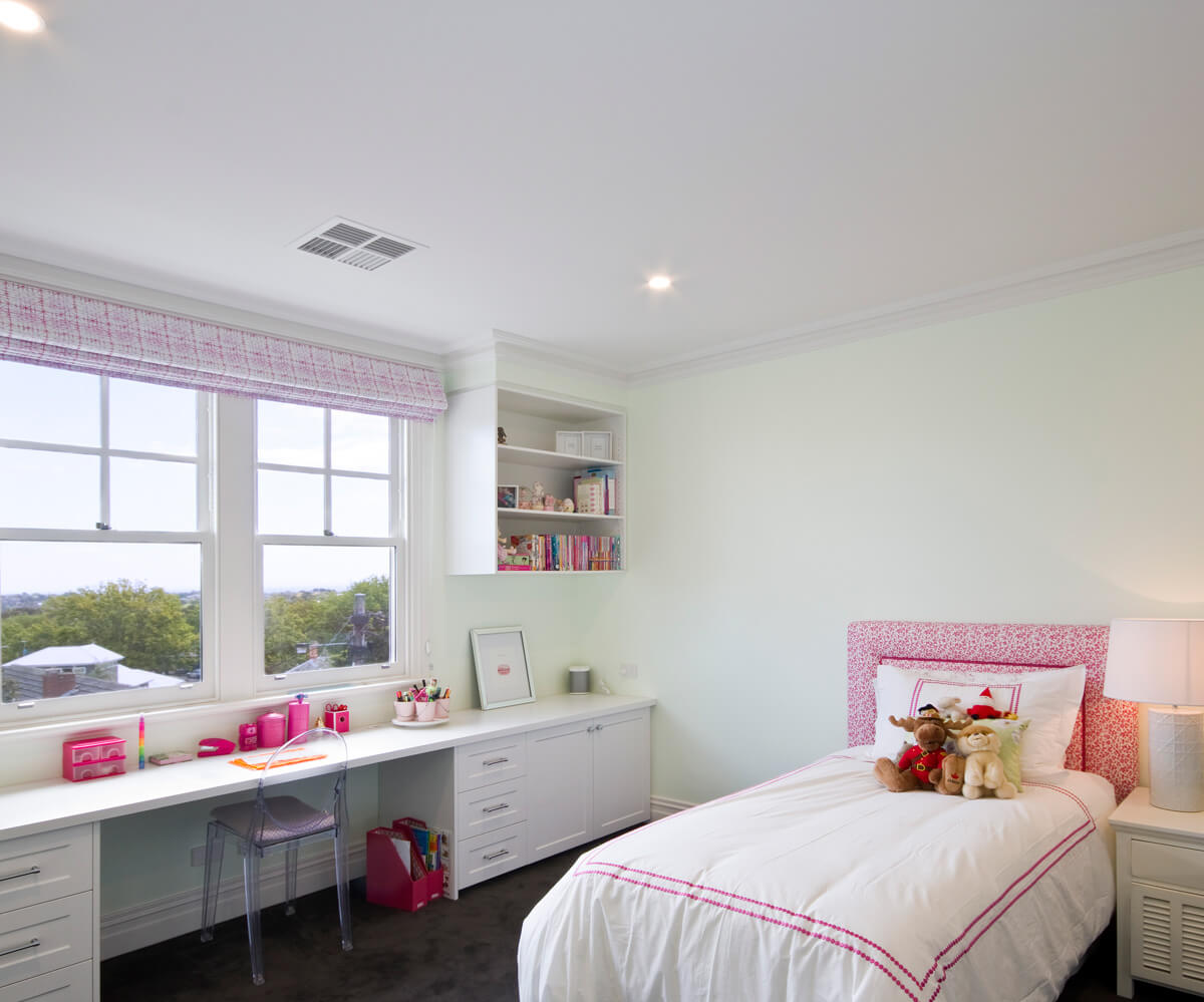 Bright bedroom with a ceiling vent supplying combined heating and cooling