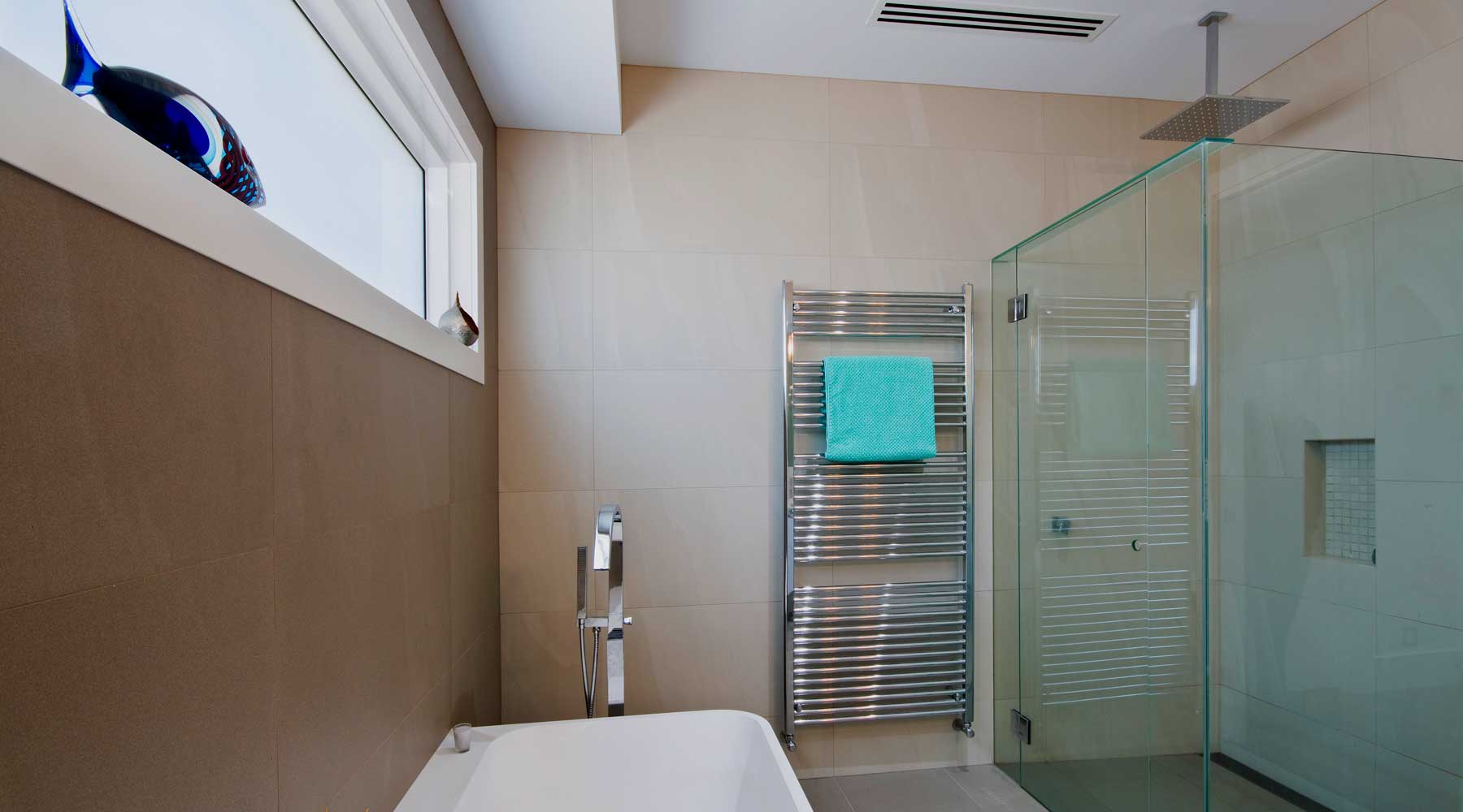 Bathroom in Game Street, Blackburn with Reverse cycle ducted air conditioning, Linear slot diffusers, Hydronic towel rails